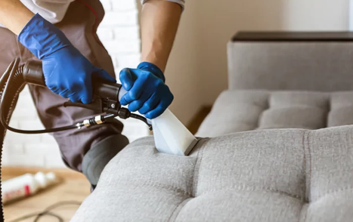 man cleaning a couch
