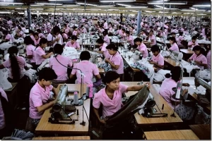 Sweatshop worker using carpet cleaner hired machine 